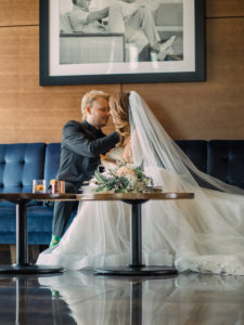 newly weds kissing on their wedding day at the AC Hotel