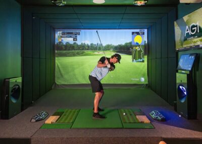 ParT Barn golf simulator in use by a guest mid swing