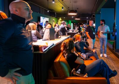 ParT Barn simulator booths with a crowd of people talking and having a good time