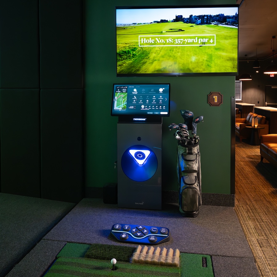 ParT Barn Golfzon simulator station with a bag of golf clubs below a screen with course information